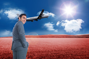 Composite image of smiling businessman standing