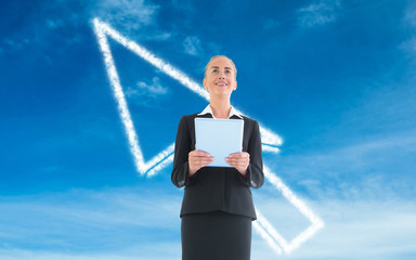 Composite image of businesswoman holding new tablet
