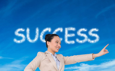 Composite image of smiling asian businesswoman pointing