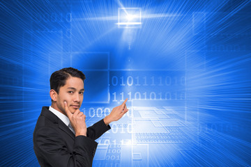 Composite image of thoughtful asian businessman pointing