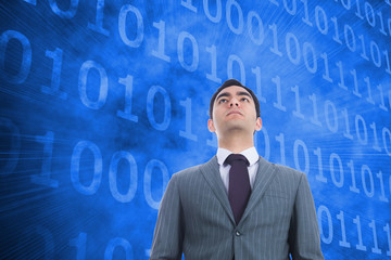 Composite image of unsmiling businessman standing