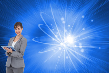 Composite image of smiling businesswoman with tablet computer