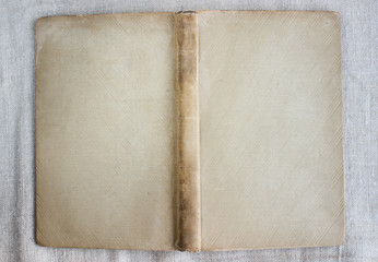 Antique book cover with spine, covered with cloth, stained.