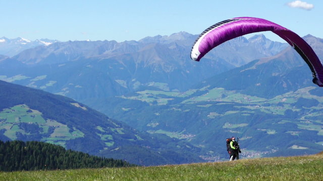 Paraglider taking off from a mountain - start, Kronplatz, Italy