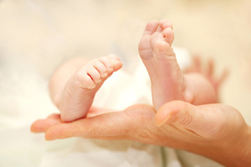 Baby feet in mother's hands.
