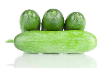 Fresh mini cucumbers on a white reflective background