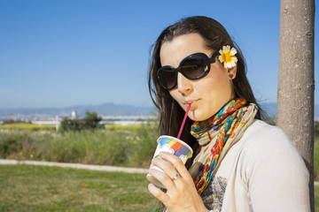 Young girl drinking soda with a straw