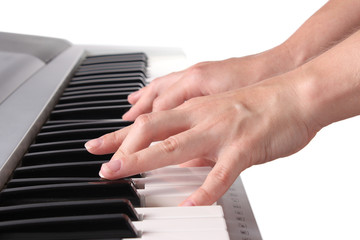 Female hands playing the piano
