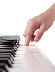 Female hand playing the piano