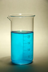 test-tube with blue liquid on grey background