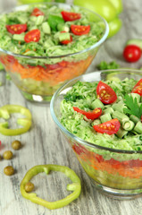 Tasty salad with fresh vegetables on wooden table