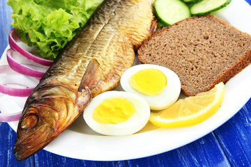 Smoked fish on plate close up