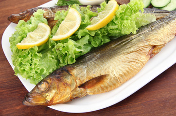 Smoked fish on plate close up