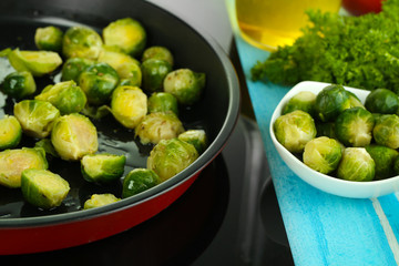 Fresh brussels sprouts in pan on cooking surface close-up