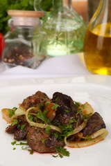 Appetizing fried chicken livers on plate close-up