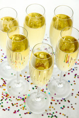 Glasses with champagne on shiny background