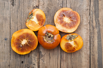 persimmons on wooden table