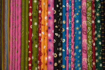Heap of cloth fabrics at a local market in India. Close up .