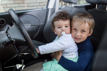 Children sit in the car