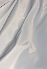 Fototapeta premium White sunlit fabric in the wind