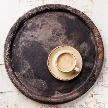Coffee cup on dark stone tray