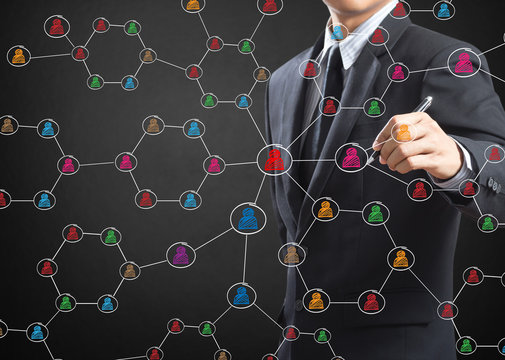 Business man drawing social network structure on a white board