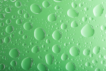 Clear green water drops over green background