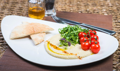 Plate with hummus dip and tapas