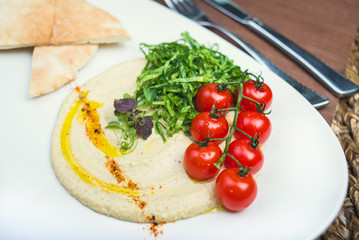 Plate with hummus dip and tapas