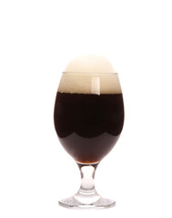 Closeup of beer glass with foam.