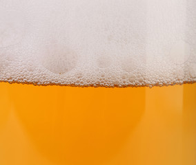 Closeup of beer with foam.