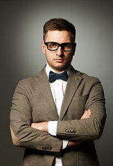 Confident nerd in eyeglasses and bow tie