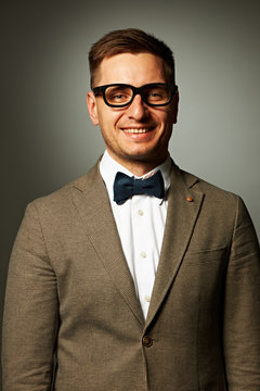 Confident nerd in eyeglasses and bow tie