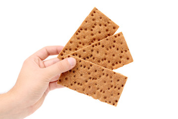 Hand holding grain crisp bread.