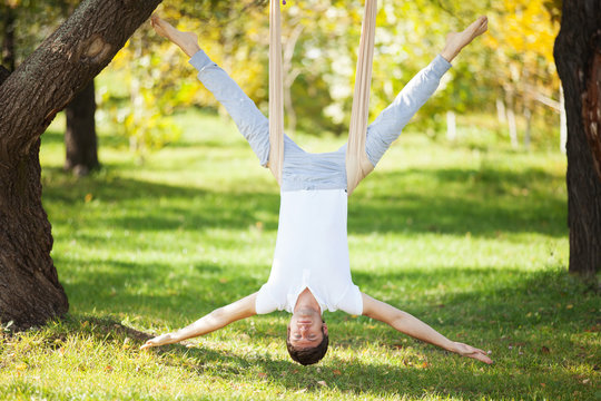 Aerial Yoga, Man Doing Yoga Exercises In The Park