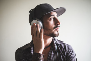 young stylish man listening to music