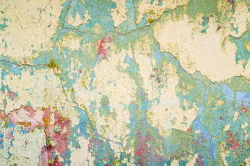 Textured wall that is crumbling with red stains