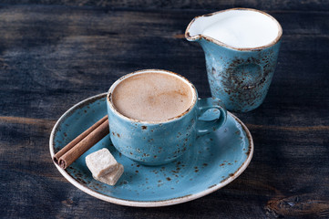 Cup of coffee with milk, cinnamon and sugar
