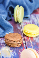 French macaroons in brown, green , yellow