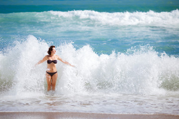 Young woman playing in big waves