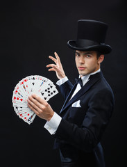 magician showing trick with playing cards