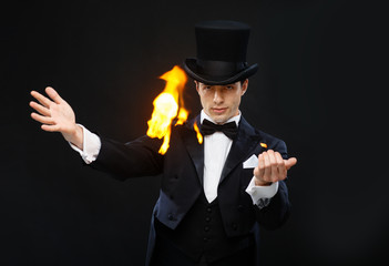 magician in top hat showing trick with fire
