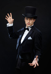 magician in top hat showing trick
