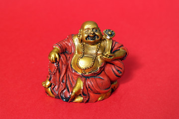 Buddha little statue with red background