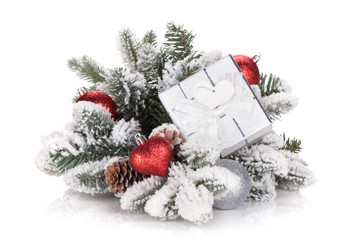 Naklejka na ściany i meble Gift box and christmas decor on snowy fir tree