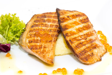 Grilled salmon fillet with vegetables and caviar