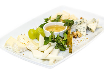 cheese plate, with several kinds of cheese on a white background