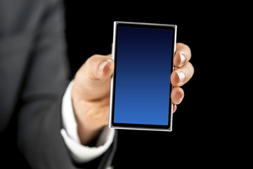 Businessman holding mobile phone with blue empty screen