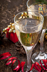Two glasses of champagne on a dark old wooden background