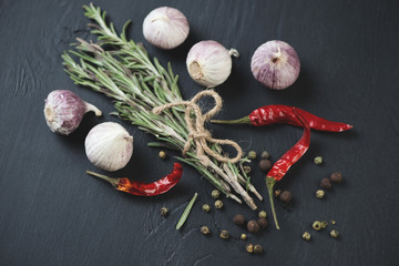 Bunch of rosemary, chinese garlic, chili peppers and peppercorns